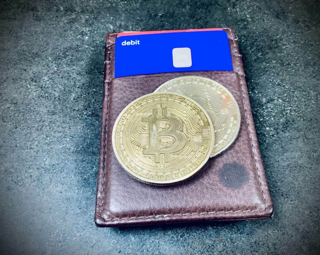 A stylized graphic representing cryptocurrency coins and a European Central Bank building.