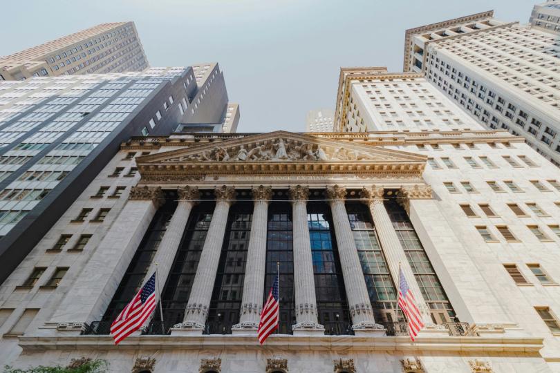 A stylized image depicting stock market charts overlaid with digital currency symbols, symbolizing the intersection of finance and cryptocurrency.