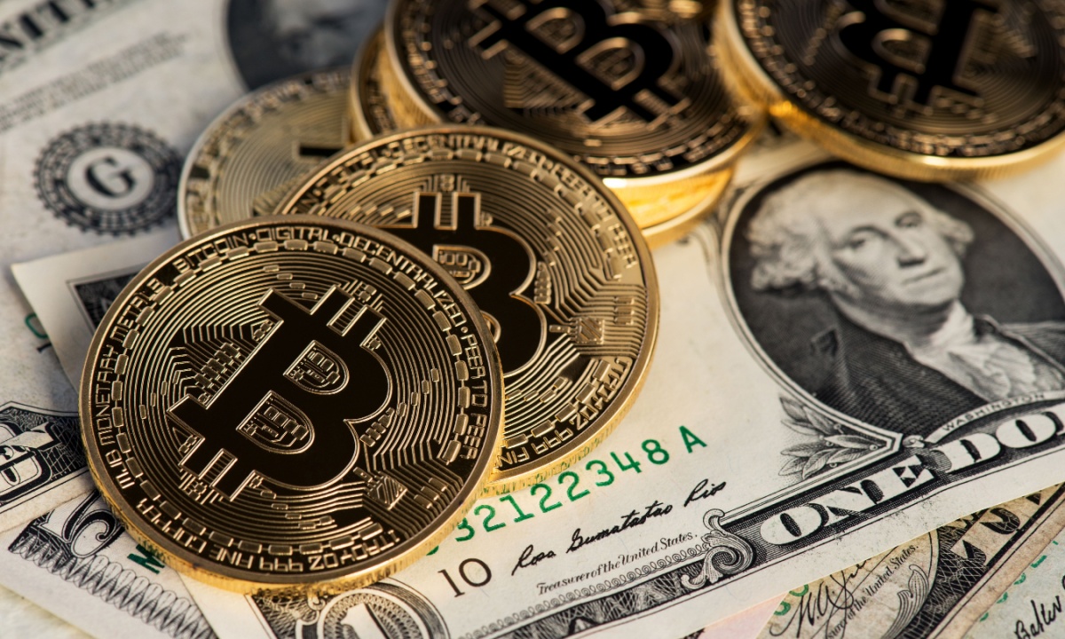 A graphic illustration showing a Bitcoin symbol overlayed on a stock market chart with a red downward trend line.