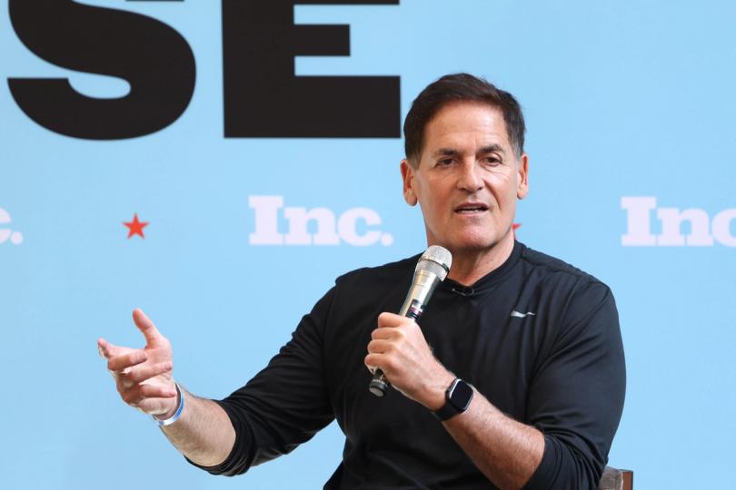 Mark Cuban looking skeptical, with cryptocurrency symbols in the background.