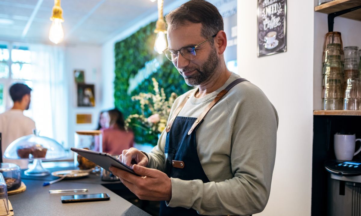 Small business owner using a smartphone to manage their online store.