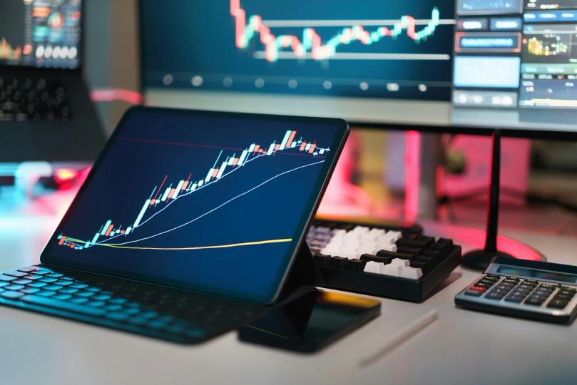 Chart showing Bitcoin price rising above $78,000 alongside a stock market graph at a new high.