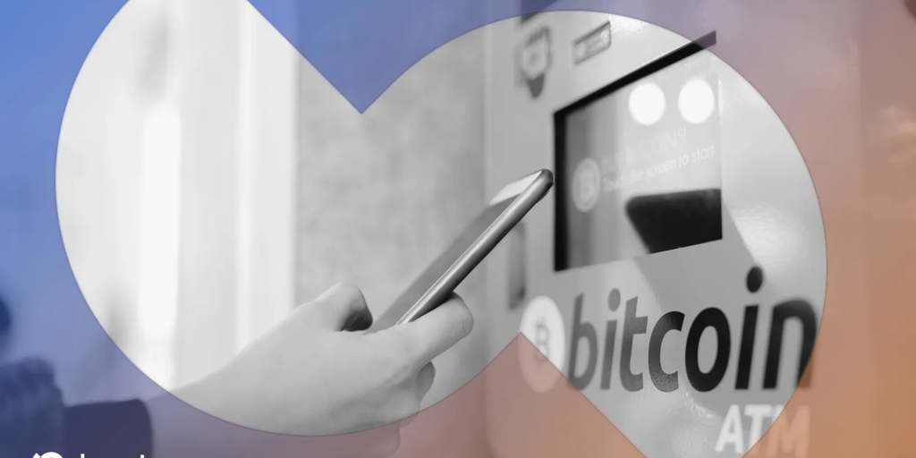 A Bitcoin ATM machine with a screen displaying cryptocurrency symbols.