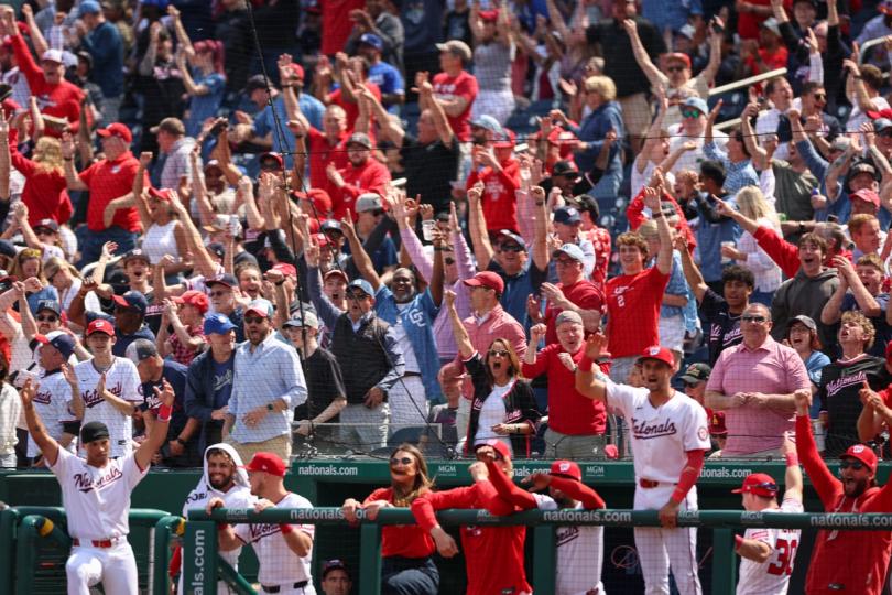 U.S. sports stadium with digital tokens floating in the air, representing fan engagement.