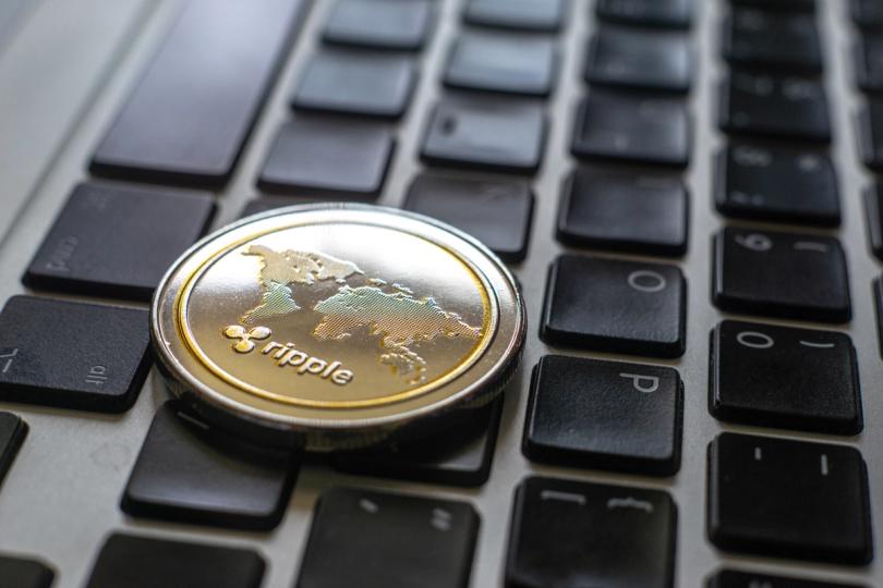 A person using a laptop, with digital network lines and security icons overlayed, symbolizing cybersecurity and threat intelligence.
